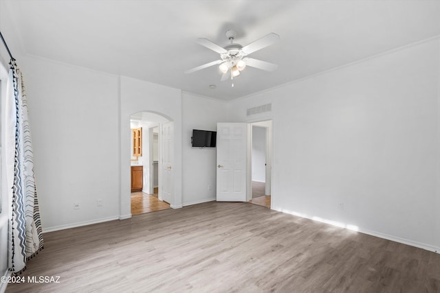 unfurnished bedroom featuring light hardwood / wood-style floors, ensuite bath, and ceiling fan