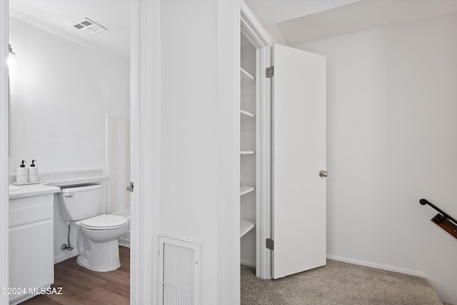 bathroom with toilet and hardwood / wood-style flooring