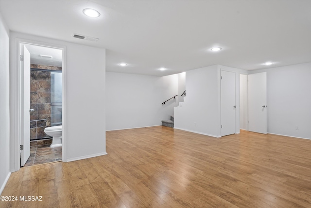 basement with light hardwood / wood-style flooring