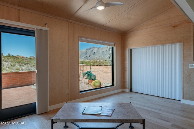 interior space with lofted ceiling, ceiling fan, wooden ceiling, a mountain view, and light wood-style floors