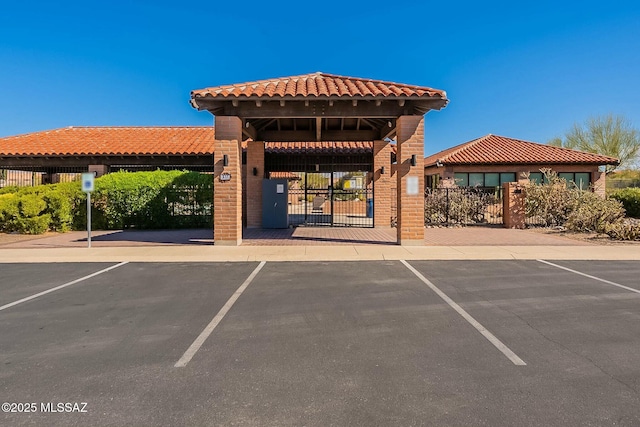 view of property with uncovered parking and fence