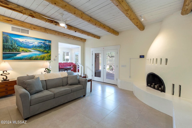 tiled living room with french doors, beam ceiling, and wooden ceiling