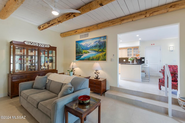 tiled living room with wood ceiling, sink, and beam ceiling