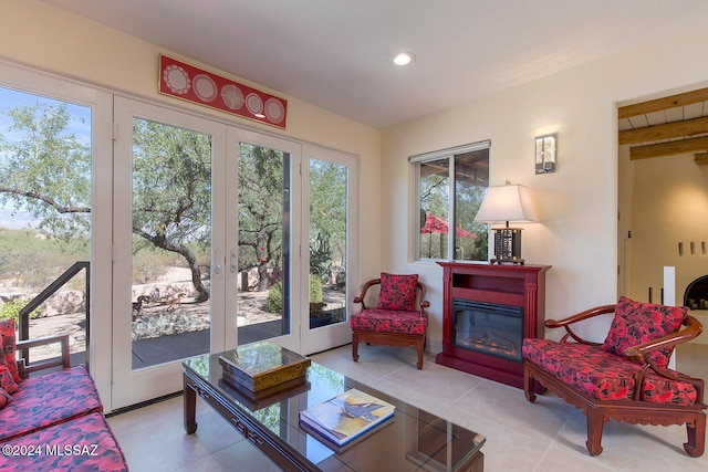 living room with a wealth of natural light, french doors, and light tile patterned floors