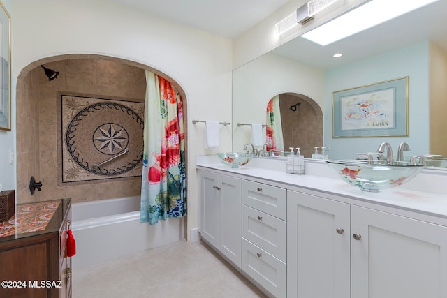 bathroom with tiled shower / bath combo and vanity