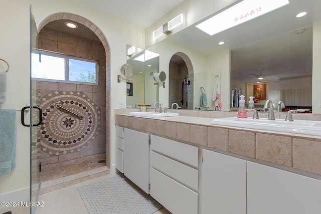 bathroom featuring tiled shower, tile patterned flooring, and vanity