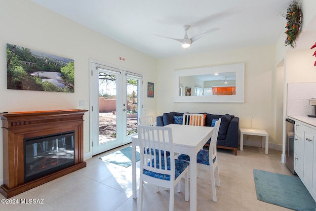 tiled dining space featuring ceiling fan and french doors