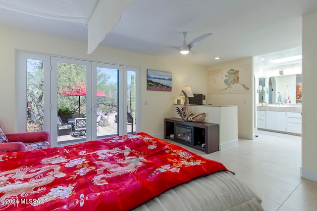 tiled bedroom with beamed ceiling, ceiling fan, connected bathroom, and access to outside