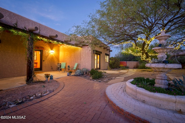 view of patio terrace at dusk