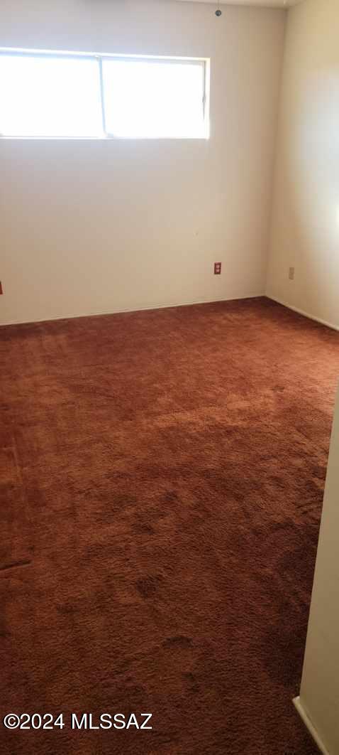 unfurnished room featuring carpet flooring