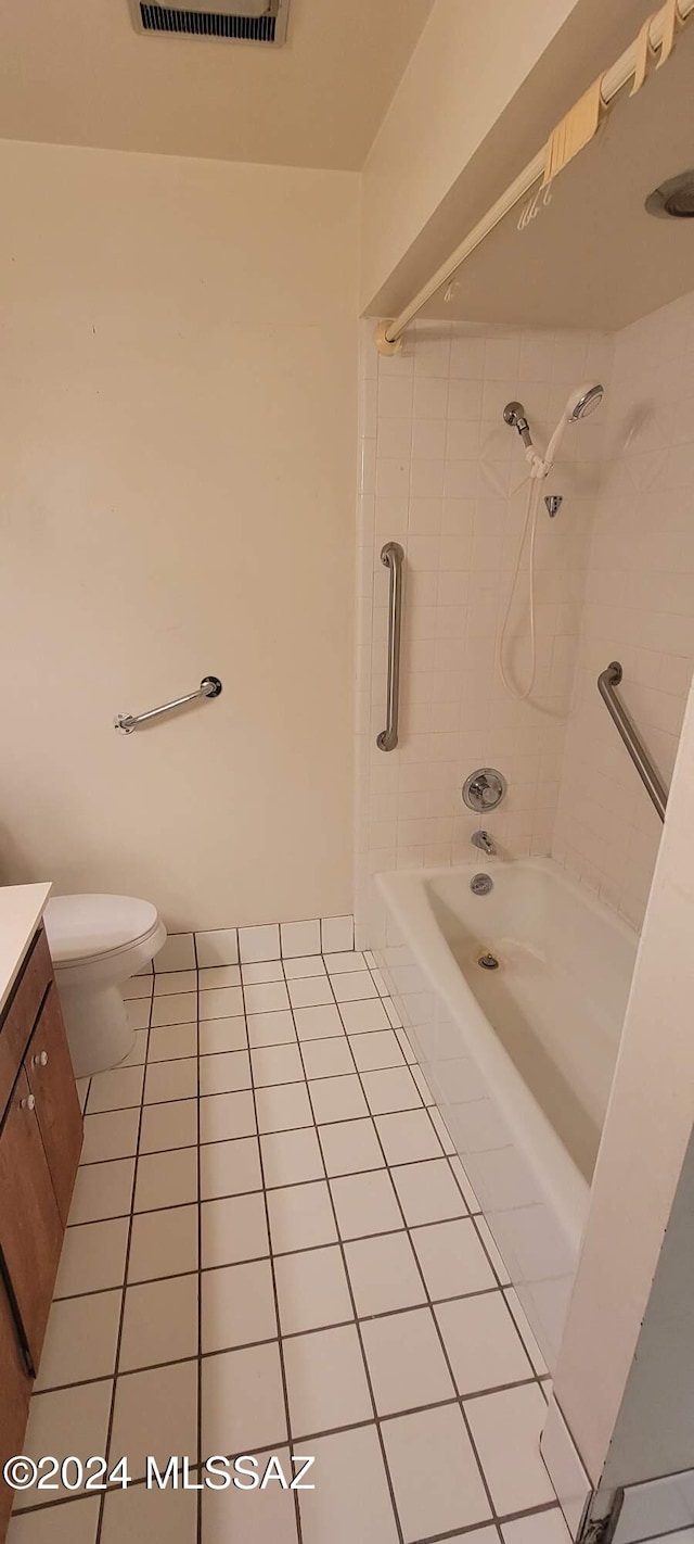 full bathroom with toilet, tile patterned flooring, tiled shower / bath combo, and vanity