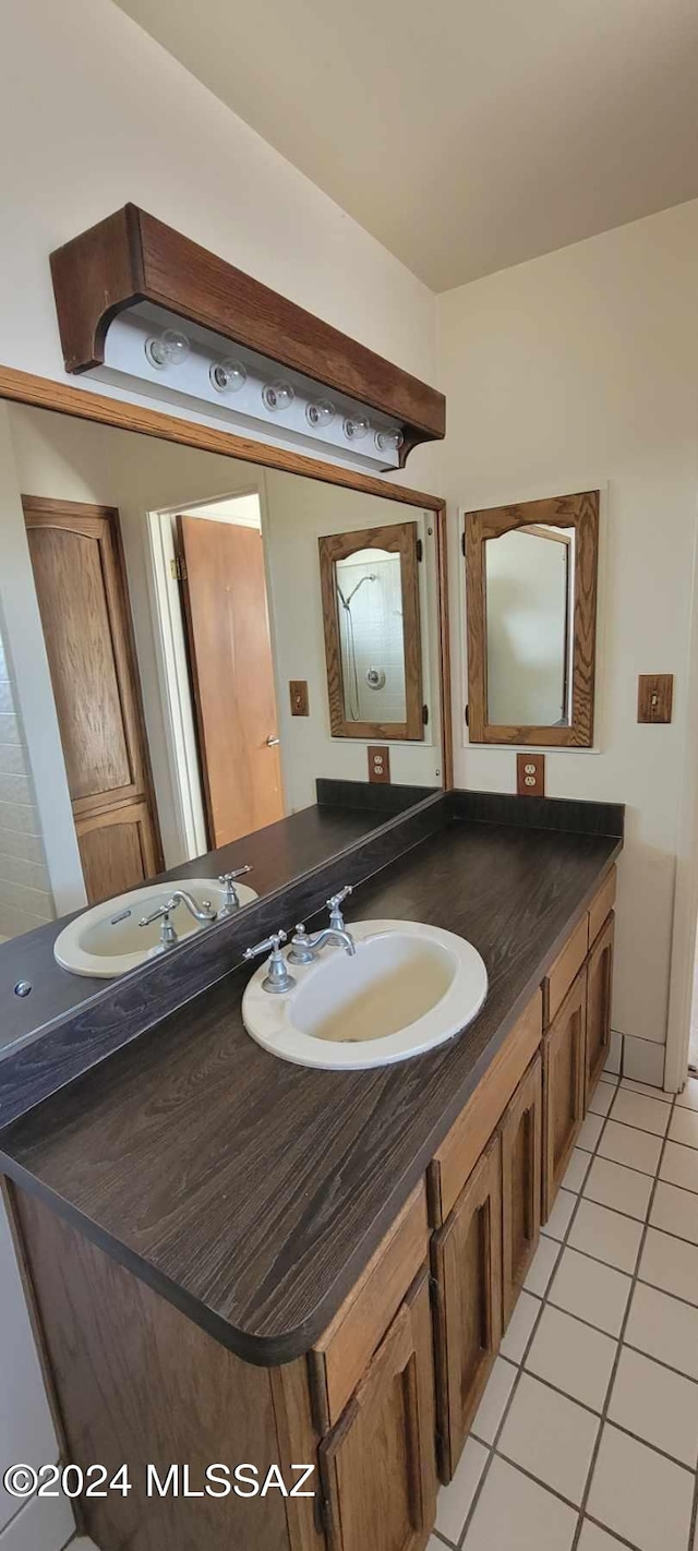 bathroom featuring tile patterned flooring and vanity