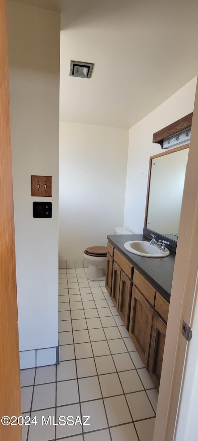 bathroom with tile patterned floors, vanity, and toilet