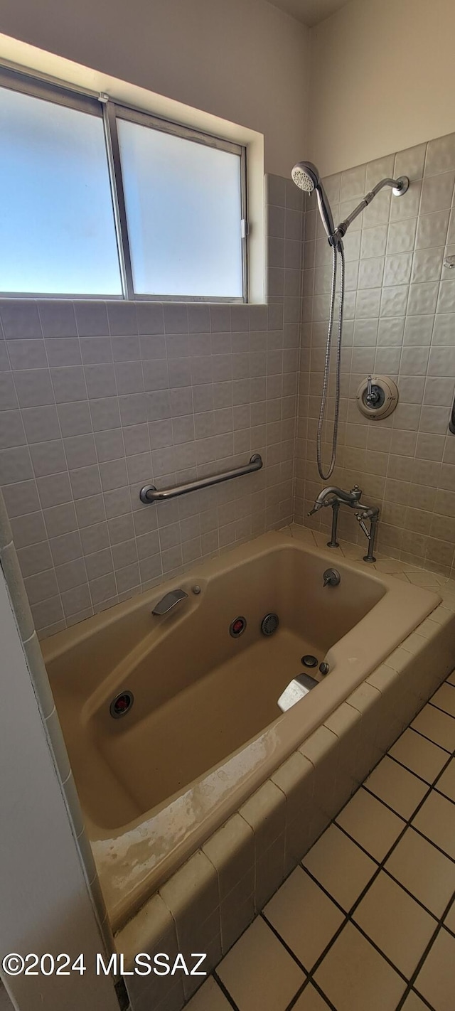 bathroom featuring tiled shower / bath combo and tile patterned flooring