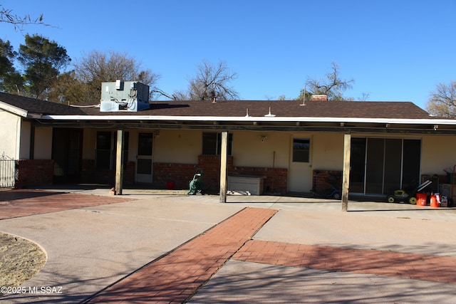 back of house with central AC unit