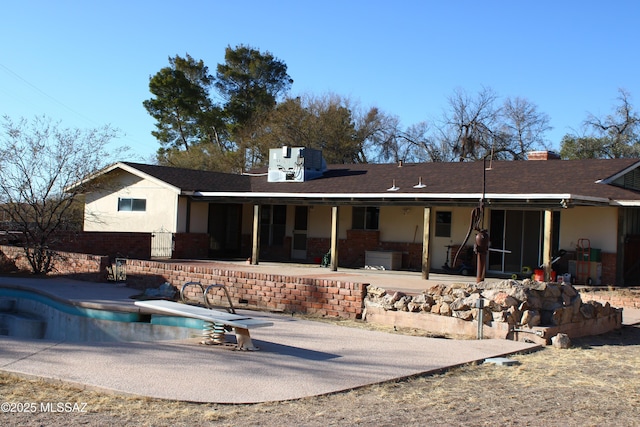 rear view of house with a patio area and central air condition unit