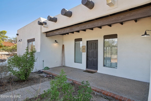 entrance to property featuring a patio area