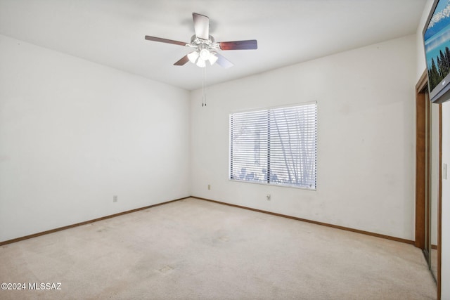 unfurnished bedroom with ceiling fan and light carpet