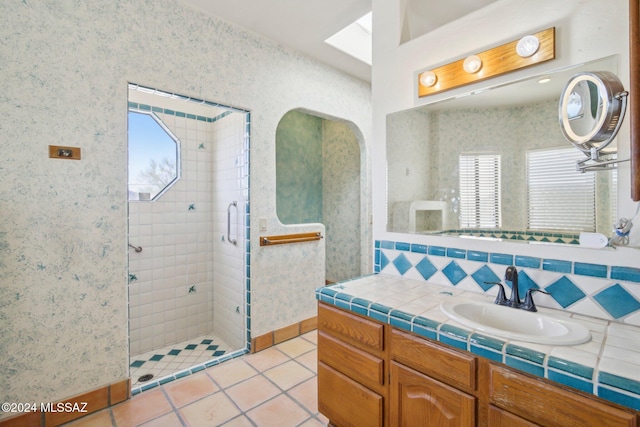 bathroom featuring walk in shower, a wealth of natural light, vanity, and tile patterned floors