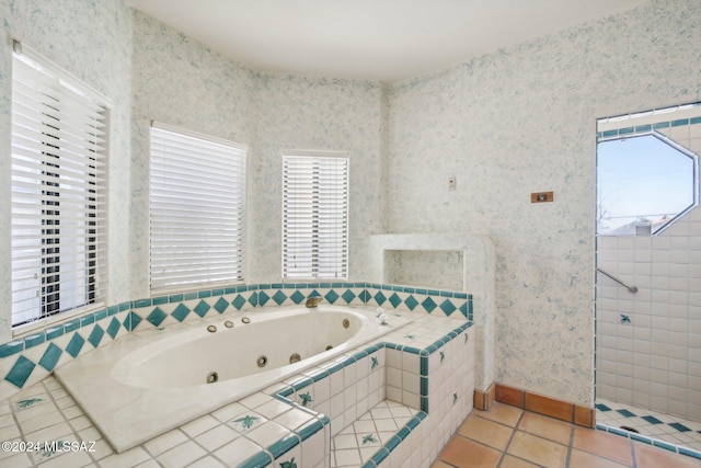 bathroom featuring tiled bath and tile patterned floors