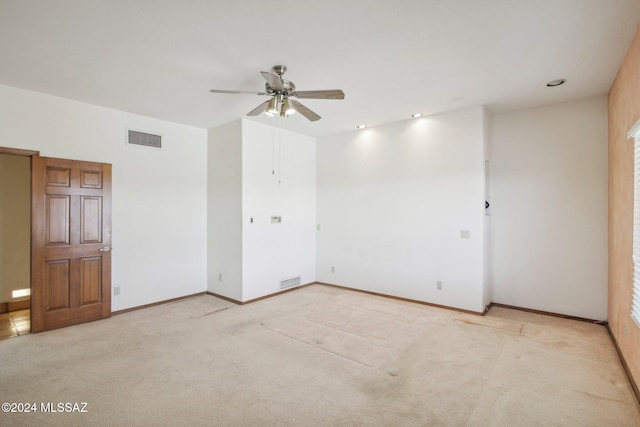 unfurnished room with ceiling fan and light carpet