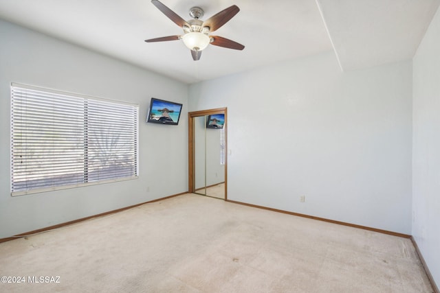 empty room featuring light carpet and ceiling fan