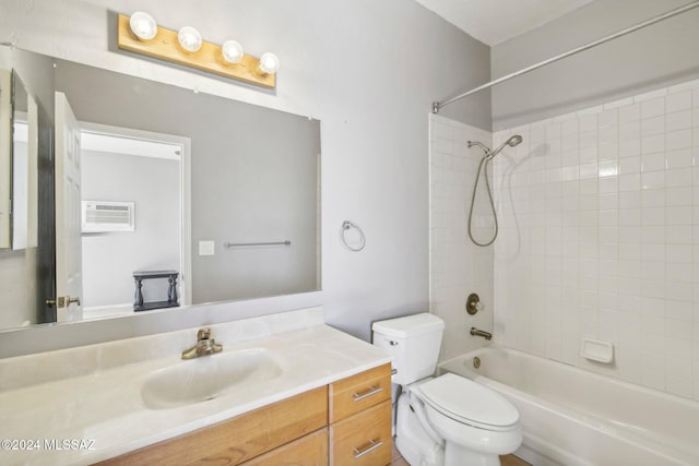 full bathroom featuring a wall mounted AC, vanity, toilet, and tiled shower / bath combo