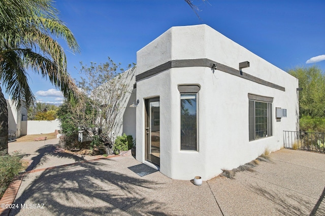 view of side of home with a patio