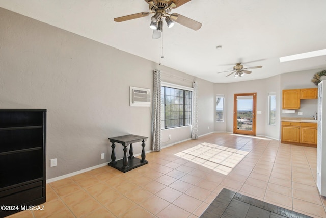 interior space featuring an AC wall unit, ceiling fan, and light tile patterned flooring