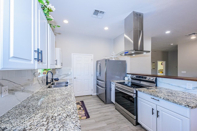 kitchen featuring island exhaust hood, sink, white cabinets, and appliances with stainless steel finishes