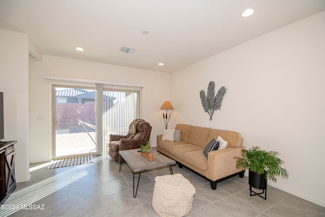 living room with baseboards, light tile patterned flooring, visible vents, and recessed lighting