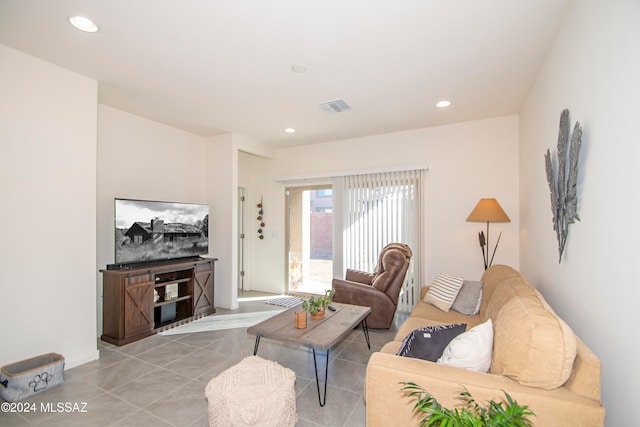 living room with light tile patterned floors, visible vents, and recessed lighting