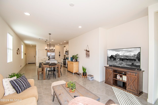 living room featuring light tile patterned floors, an inviting chandelier, and recessed lighting