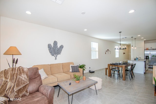 living room with light tile patterned floors, visible vents, a notable chandelier, and recessed lighting