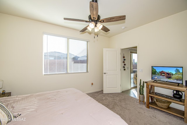 bedroom with carpet floors, a ceiling fan, and baseboards