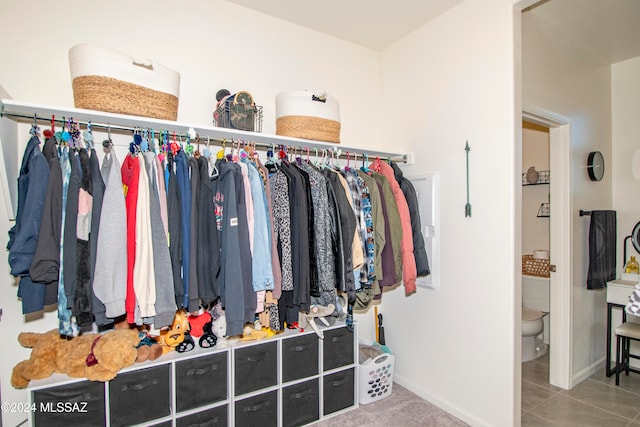 walk in closet with tile patterned floors