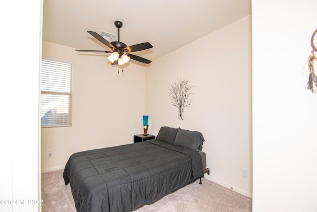 bedroom featuring light carpet, a ceiling fan, visible vents, and baseboards