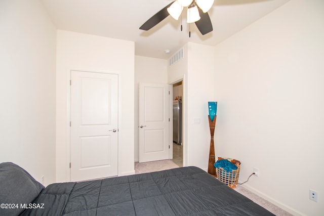 unfurnished bedroom featuring visible vents, baseboards, a ceiling fan, and freestanding refrigerator