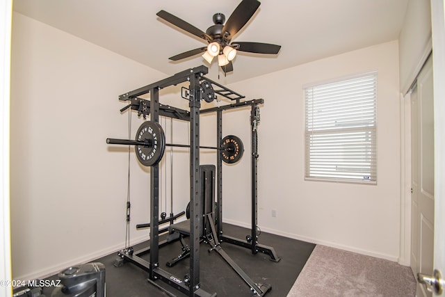 exercise room featuring baseboards and a ceiling fan