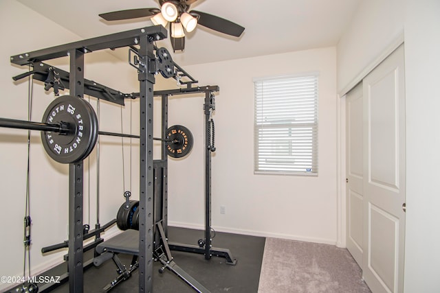 exercise area with ceiling fan and baseboards