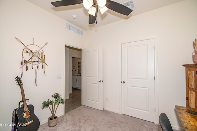 bedroom with light colored carpet, visible vents, ceiling fan, and baseboards