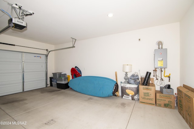 garage with water heater and a garage door opener