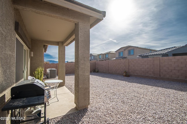 view of yard featuring a patio area, a fenced backyard, and cooling unit