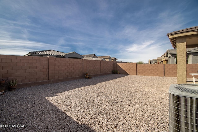 view of yard with cooling unit and a fenced backyard