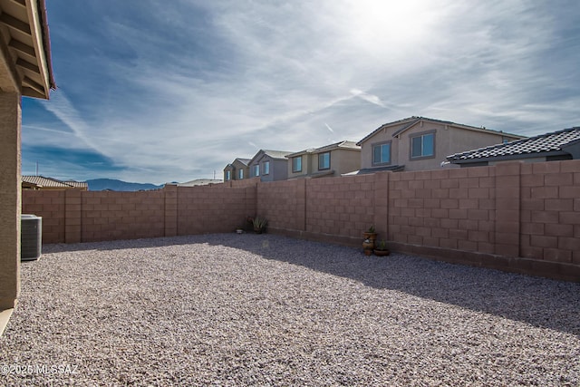 view of yard featuring a fenced backyard and central air condition unit