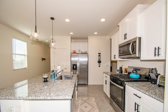 kitchen featuring recessed lighting, stainless steel appliances, a sink, white cabinets, and a center island with sink