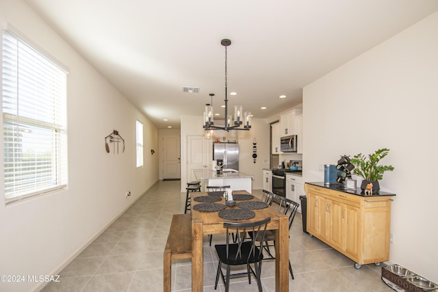 dining room featuring light tile patterned floors, baseboards, visible vents, and recessed lighting