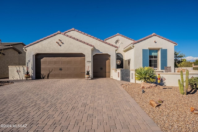 mediterranean / spanish house featuring a garage