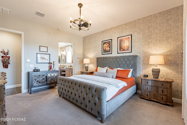 bedroom featuring carpet flooring, an inviting chandelier, and connected bathroom