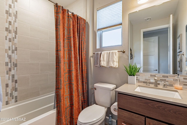 full bathroom featuring toilet, vanity, shower / bath combo with shower curtain, and decorative backsplash